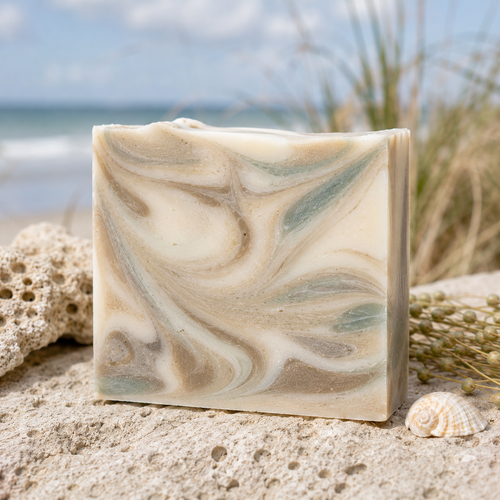 Coquina Body Bar - handcrafted soap with sandy cream and sage swirls on a beach